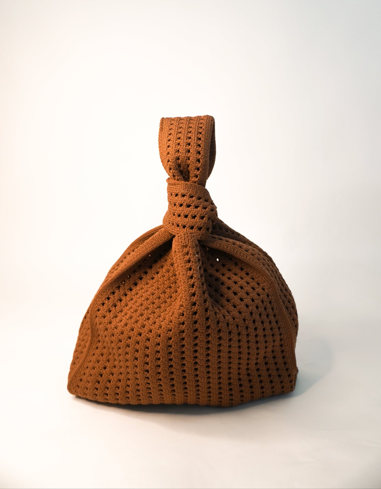 Brown knitted bag on a white background